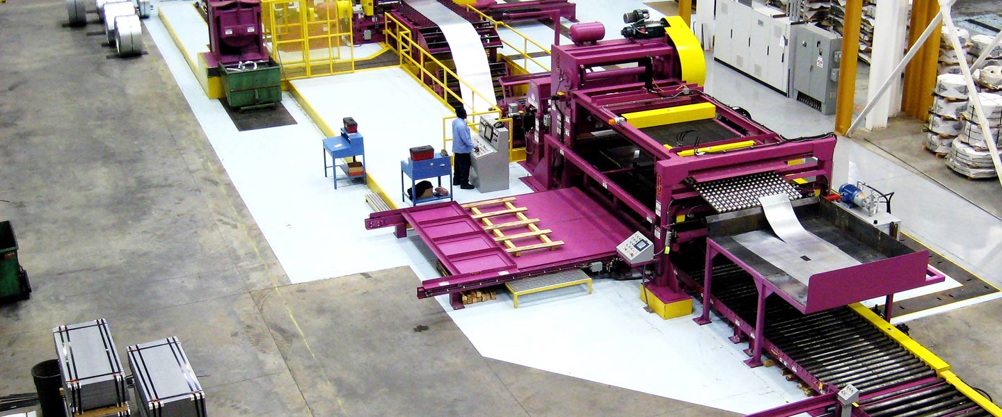 Industrial metal processing machine with magenta framework and conveyor system feeding sheet metal through rollers.