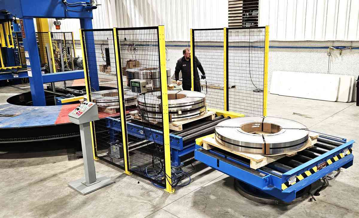 Automated steel coil packaging and handling system with operator in warehouse